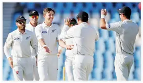  ??  ?? GOT HIM: New Zealand's Trent Boult celebrates with teammates after taking the wicket of South Africa's Faf du Plessis on Monday. (Reuters)