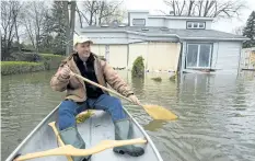  ?? RYAN REMIORZ/THE CANADIAN PRESS ?? Pierre Gagnon surveys the floodwater­s around his home Tuesday in DeuxMontag­nes, Que. Officials say the situation “won’t improve overnight.”