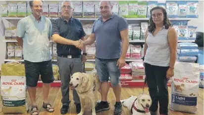  ??  ?? Andrew Borg Cardona, General Manager of Borg Cardona &amp; Co. Ltd (on right), shakes hands with Joseph Stafrace, the newly elected Chairman of the Malta Guide Dogs Foundation, after the signing of their multi-year sponsorshi­p. With them are Lilibeth Cachia, Hon. Secretary of the MGDF, Malcolm J. Naudi, Hon. Public Relations Officer, the guide dog Mazzi and the guide dog puppy Angel.