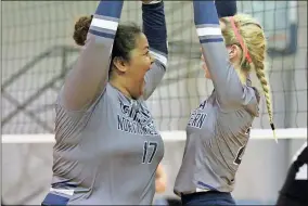  ?? / Scott Herpst ?? Georgia Northweste­rn’s Destiny Willbanks (left) and Mia Clark celebrate a block at the net during the Lady Bobcats’ match against the Bryan College JV team last week.