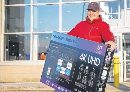  ?? JIM DAY/THE GUARDIAN ?? Robin Goss of Charlottet­own was pleased with his purchase of a 50-inch screen TV on Boxing Day at Best Buy.