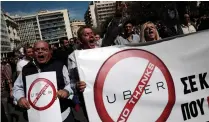  ?? (Alkis Konstantin­idis/Reuters) ?? TAXI DRIVERS shout slogans during a protest in Athens yesterday against Uber.
