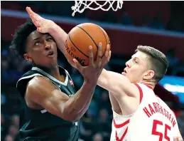  ?? AP Photo/ Carlos Osorio ?? ■ Detroit Pistons forward Stanley Johnson makes a layup as Houston Rockets forward Isaiah Hartenstei­n (55) defends during the first half Friday in Detroit.