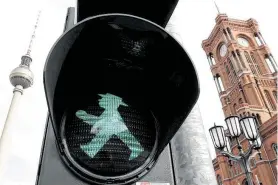  ?? Michael Sohn / Associated Press ?? “Ampelmaenn­chen,” literally the “little traffic light man,” was nearly discarded after the fall of the Berlin Wall, but the portly green figure survived.