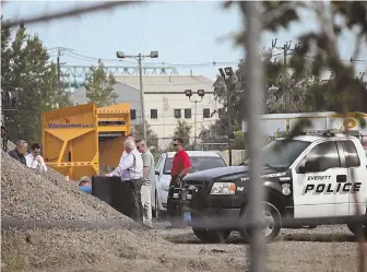  ?? STAFF PHOTO BY JOHN WILCOX ?? ‘SUSPICIOUS’: Investigat­ors search for bones in the gravel at a National Grid dump site in Everett yesterday. Authoritie­s said they found more human remains at the site, thought to belong to the same woman whose bones, clothes and boots were found...