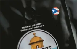  ?? KENDALL WARNER/STAFF ?? A sticker featuring the Puerto Rican flag is on a bag of roasted coffee beans from Rich Port Coffee at its storefront in the lobby of the Truist Building in Norfolk.