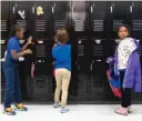  ?? ASHLEE REZIN GARCIA/SUN-TIMES ?? Students put coats in their lockers at Roswell B. Mason Elementary School on the South Side.