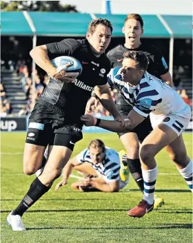  ??  ?? Running clear: Alex Goode beats the Bath cover to set up a Saracens try