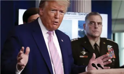  ?? Photograph: Alex Brandon/AP ?? Gen Mark Milley looks on as Donald Trump at the White House in 2020.