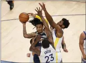  ?? NHAT V. MEYER — BAY AREA NEWS GROUP ?? The Grizzlies' Ja Morant (12) passes the ball against Warriors Draymond Green (23) and Andrew Wiggins (22) in the fourth quarter of Game 2.