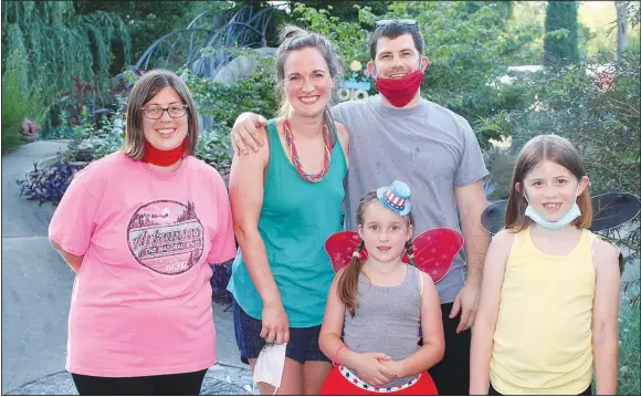  ?? (NWA Democrat-Gazette/Carin Schoppmeye­r) ?? Beth Cowen (from left), Tessa Minor and Brent Borden, Mayah Cowen and Emily Cowen enjoy a Magical Evening in the Garden on July 12 at the Botanical Garden of the Ozarks in Fayettevil­le.
