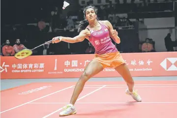  ?? — AFP photo ?? Sindhu Pusarla of India hits a return against Nozomi Okuhara of Japan during their women’s singles final match at the 2018 BWF World Tour Finals badminton competitio­n in Guangzhou in southern China’s Guangdong province.
