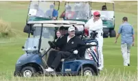  ?? AP ?? president Trump sits in a golf cart as he plays a round of golf on the Ailsa course in Turnberry, southwest of Glasgow. —