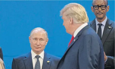  ?? /AFP ?? Eye contact: In this file photo US President Donald Trump, right, looks at Russia’s President Vladimir Putin as they take their places for a photo during the Group of 20 leaders summit in Buenos Aires on November 30, 2018.