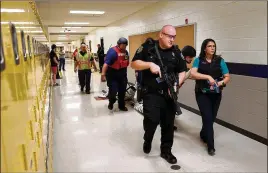  ?? JASON GETZ/AJC 2022 ?? The Cherokee Sheriff’s Office conducts an active shooter drill in June at Mill Creek Middle School in Woodstock. The Georgia Senate passed a bill Monday to require “intruder alert” drills in all public schools by Oct. 1 of each year.