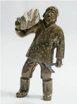  ??  ?? Kellypalik Qimirpik
(b. 1948 Kinngait) Man Carrying Stone 2010 Serpentini­te and baleen 31.8 x 15.2 x
12.7 cm Courtesy Canadian Arctic Producers Photo Erin Yunes, Abbott Imaging