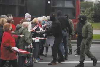  ?? Associated Press ?? People, most of them elderly women, argue with plaincloth­es police officers during an opposition rally to protest the official presidenti­al election results in Minsk, Belarus.