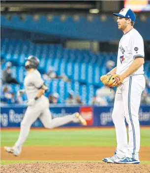  ?? CARLOS OSORIO/TORONTO STAR ?? Giancarlo Stanton rounds the bases, the second Yankee to go deep on Jays reliever Joe Biagini in the 13th inning of Wednesday night’s game at the Rogers Centre.