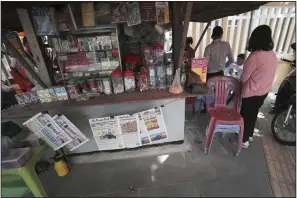  ?? (AP/Heng Sinith) ?? Local newspapers Nokor Thum (two copies at left), in the Khmer language, the Phnom Penh Post (center) and Khmer Times are for sale at a stand on a sidewalk near Monument Independen­ce in Phnom Penh, Cambodia, on Friday.