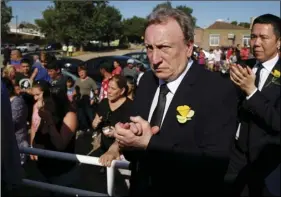  ??  ?? Cardiff City manager Neil Warnock (second right) and Cardiff City CEO Ken Choo (right) applaud during the burial of Emiliano Sala, at the cemetery in Santa Fe, Argentina, on Saturday. AP PHOTO/NATACHA PISARENKO