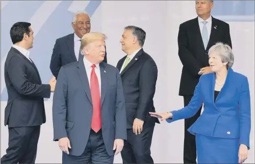  ??  ?? President Donald Trump and Prime Minister Theresa May at the Nato summit in Brussels. Mr Trump has denounced Germany as a ‘captive’ of Russia.