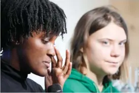  ?? AP PHOTO/MARKUS SCHREIBER ?? Climate activist Vanessa Nakate of Uganda, left, reacts beside Greta Thunberg of Sweden at a Thursday press conference at the World Economic Forum in Davos, Switzerlan­d.