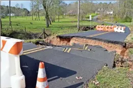  ?? Blake Silvers ?? Above: Moore’s Ferry Road at Miller Loop in Gordon County remained closed Friday after a portion of the asphalt was washed away Thursday when around 5 inches of rain fell across the area. Left: The Oostanaula River was above 27 feet at the Fifth Avenue Bridge on Friday afternoon. The National Weather Service expects the crest to be just under 28 feet Saturday morning.