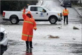  ?? JAMES QUIGG — THE DAILY PRESS VIA AP ?? Victorvill­e Public Works staff redirect traffic on Pebble Beach Drive as they closed the roadway due to flooding, Thursday in Victorvill­e.