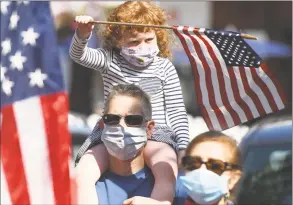  ?? Tyler Sizemore / Hearst Connecticu­t Media ?? Stamford resident Gregory Lodato’s daughter, Victoria, 4, waves an American flag from upon his shoulders during the rally to keep the Christophe­r Columbus statue in Columbus Park in Stamford on Sunday.