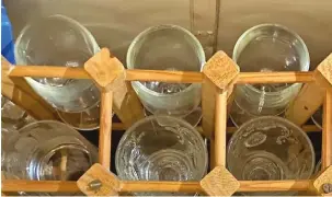  ?? ?? Below: Glass stowage made from a wooden wine rack aboard Constance