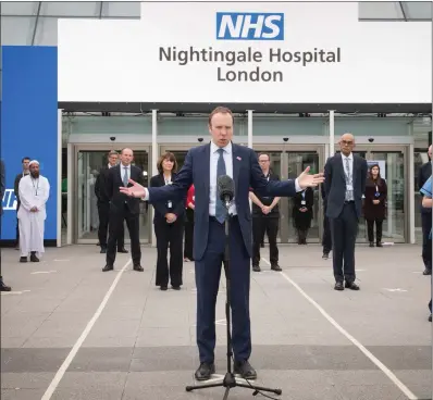  ??  ?? Health Secretary, Matt Hancock, seen opening the NHS Nightingal­e Hospital in London, has changed views on migrant NHS staff