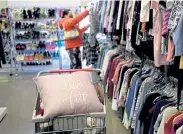  ?? Matthew Jonas, Daily Camera ?? Rachel Castillo of Erie shops Tuesday at the Sister Carmen Thrift Store in Lafayette. After a six- month closure because of the pandemic, the store is open by appointmen­t only.