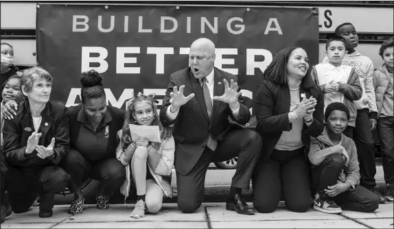  ?? PHOTOS BY ANNA ROSE LAYDEN / THE NEW YORK TIMES ?? Mitch Landrieu, center, a senior adviser and infrastruc­ture coordinato­r for the White House, visits with schoolchil­dren and staffers Oct. 26 at John Lewis Elementary School in Washington. The former New Orleans mayor is now responsibl­e for ensuring that equity is at the center of President Joe Biden’s $1 trillion infrastruc­ture investment­s.