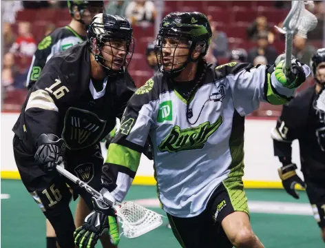  ?? GERRY KAHRMANN ?? Vancouver Warriors’ Mitch Jones, left, pursues ball-carrier Jeremy Thompson of the Saskatchew­an Rush in NLL play Saturday.