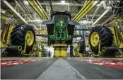  ?? ZACH BOYDEN-HOLMES — TELEGRAPH HERALD ?? Workers assemble a tractor at John Deere’s Waterloo, Iowa, assembly plant.