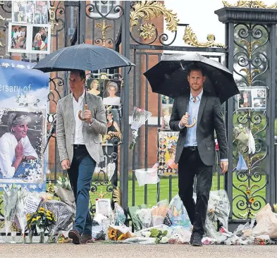  ??  ?? The Duke of Cambridge and Prince Harry depart yesterday after viewing tributes to their mother which were attached to the Golden Gates of Kensington Palace.