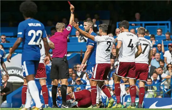  ??  ?? Chelsea captain and defender Gary Cahill (centre) is shown a red card by referee Craig Pawson after a foul on Burnley midfielder Steven Defour during the English Premier League match at Stamford Bridge in London yesterday. — AFP Off you go!