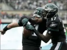  ?? MICHAEL PEREZ — THE ASSOCIATED PRESS ?? Philadelph­ia Eagles’ Alshon Jeffery, right, and Carson Wentz celebrate after Jeffery’s touchdown during the first half of an NFL football game against the Denver Broncos, Sunday in Philadelph­ia.