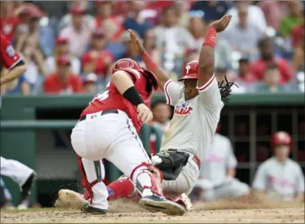  ?? NICK WASS — THE ASSOCIATED PRESS ?? Philadelph­ia Phillies’ Maikel Franco, right, slides home to score against Washington Nationals catcher Spencer Kieboom during the seventh inning of a baseball game Saturday in Washington. The Phillies won 5-3.