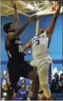  ?? DAVID M. JOHNSON - DJOHNSON@ DIGITALFIR­STMEDIA.COM ?? La Salle’s Ray Evans (3) lays the ball in as he is fouled by Lansingbur­gh’s Andre Mays during a Colonial Council boys basketball game Dec. 12, 2017at La Salle in Troy, N.Y.