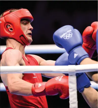  ??  ?? AdamNolan (left) exchanges punches with Andrey Zamkovoy of Russia during their men’s welter 69 kg. round of 16 bo