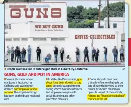  ?? AP ■ ?? People wait in a line to enter a gun store in Culver City, California.