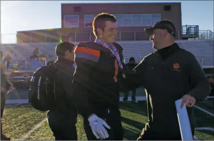  ?? Sheila Miller/ The Taos News ?? Aidan Leblanc and coach Art Abreu Jr. embrace after the Taos Tigers 14-7 state championsh­ip victory over Bloomfield Dec. 1.