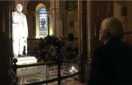  ?? ANDREW CASS — THE NEWS-HERALD ?? Tim Garfield looks at the statue of his great great grandfathe­r President James A. Garfield Nov. 17at a wreath laying ceremony in honor of the president’s 187th birthday.