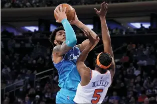  ?? JOHN MINCHILLO — THE ASSOCIATED PRESS ?? Charlotte Hornets forward Miles Bridges (0) shoots against Knicks guard Immanuel Quickley (5) during Monday’s game.