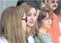  ?? ANDREW VAUGHAN THE CANADIAN PRESS ?? Mariana Navarro, centre, tears up at Sunday’s service at the Swissair memorial. Navarro’s grandmothe­r died in the crash.