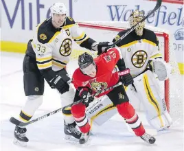  ?? JUSTIN TANG, THE CANADIAN PRESS ?? Bruins defenceman Zdeno Chara tries to clear Senators forward Mark Stone from in front of goaltender Tuuka Rask during action in Ottawa.
