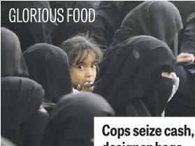  ?? Picture: EPA-EFE ?? A Yemeni child sits among burqa clad women waiting for food supplies during the Muslim fasting month of Ramadan in Yemen.