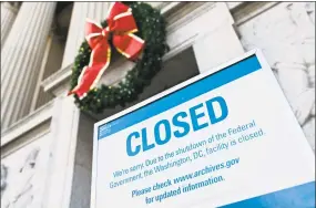 ?? Andrew Caballero-Reynolds / AFP / Getty Images ?? A sign is displayed at the National Archives building that is closed because of a U.S. government shutdown in Washington on Saturday. The shutdown is set to stretch on through Christmas as the Senate adjourned with no deal to end it in sight.