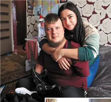  ?? afp ?? Unwavering support: Kucherenko and Veronika posing for a picture at their home in the town of Bila Tserkva, ukraine. (Below) Valeriya helping her father eat lunch at their home. —